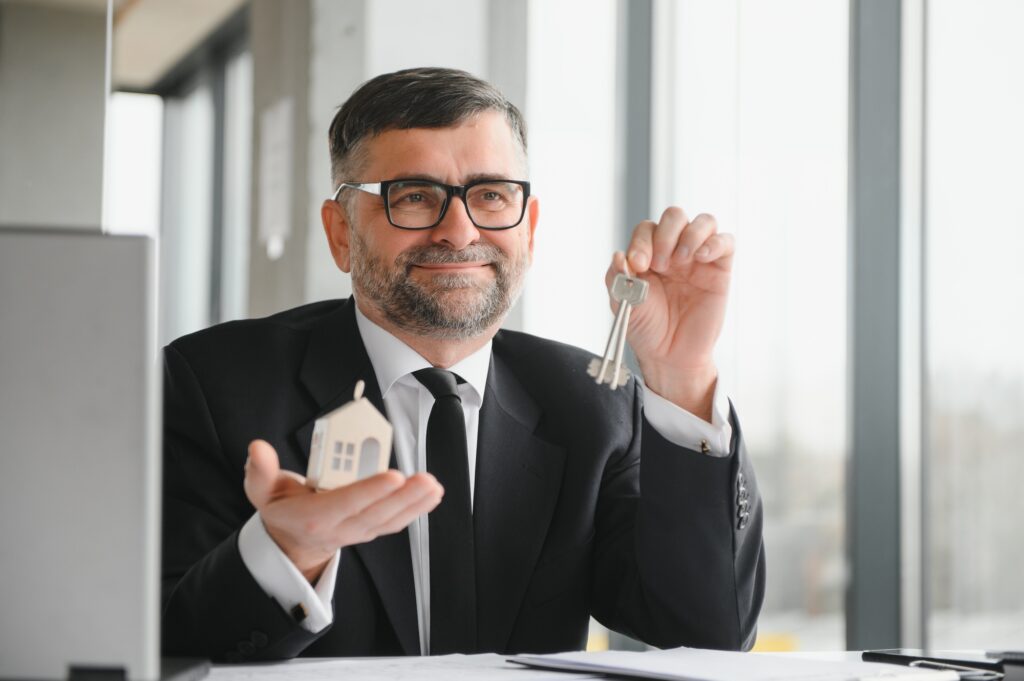 Real estate agent with house model and keys